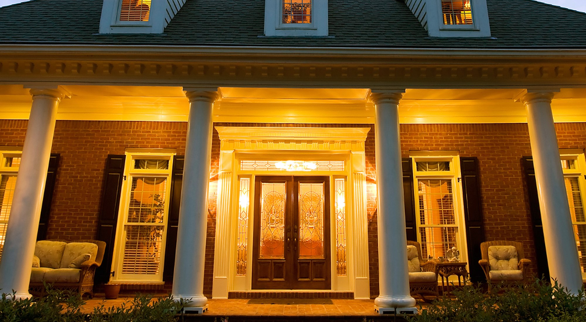 A Gulf Coast home lit warmly at night